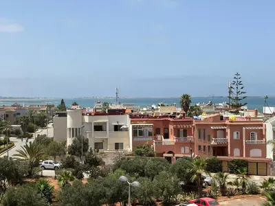 a view of a city with houses and the ocean at La siesta beach resort Mohammedia vue mer panoramique in Mohammedia