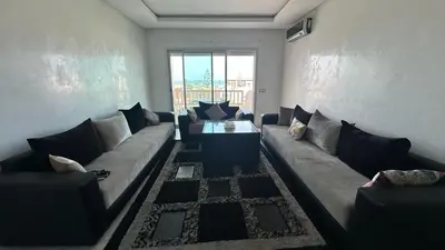 a living room with a couch and a table at La siesta beach resort Mohammedia vue mer panoramique in Mohammedia