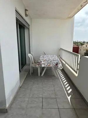 a patio with a table and chairs on a balcony at La siesta beach resort Mohammedia vue mer panoramique in Mohammedia