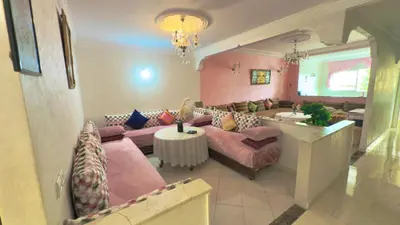 a living room with couches and a table at Immense appartement familial vue sur mer in Rabat