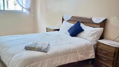a bedroom with a bed with blue and white pillows at Immense appartement familial vue sur mer in Rabat
