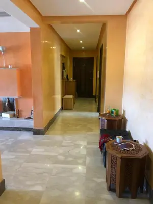a room with two tables and a hallway with a room at Apartment Galia Mohammedia in Mohammedia