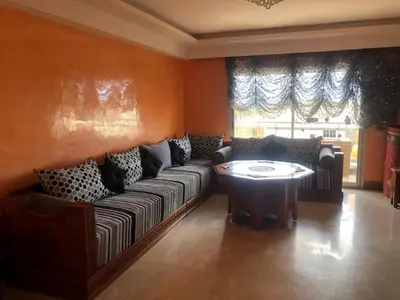 a living room with a couch and a table at Apartment Galia Mohammedia in Mohammedia