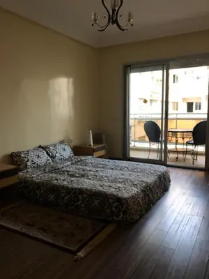 a bedroom with a bed and a large window at Apartment Galia Mohammedia in Mohammedia