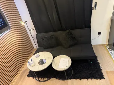 a living room with two tables and a couch at Studio au Cœur de Rabat in Rabat