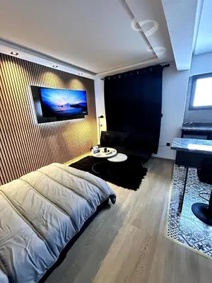 a bedroom with a bed and a table and a piano at Studio au Cœur de Rabat in Rabat