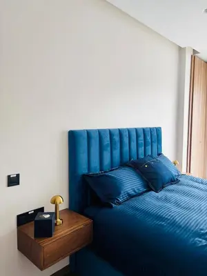 a blue bed with a blue headboard in a room at Premium Apt Casa City Center in Casablanca