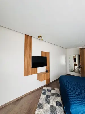 a bedroom with a bed and a tv on the wall at Premium Apt Casa City Center in Casablanca
