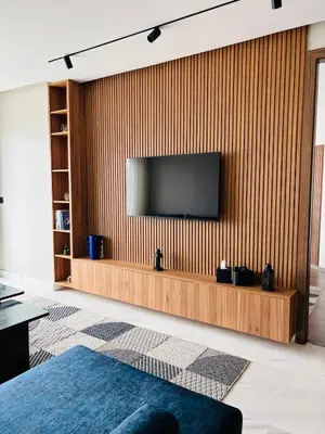 a living room with a television on a wooden wall at Premium Apt Casa City Center in Casablanca