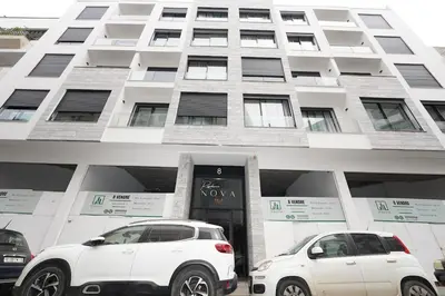 two white cars parked in front of a building at Exclusive Apt Casa City Center in Casablanca