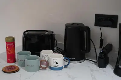 a counter top with coffee cups and a toaster at Exclusive Apt Casa City Center in Casablanca