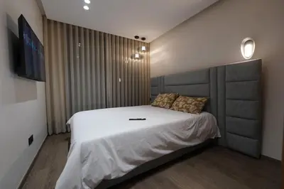 a bedroom with a large bed and a flat screen tv at Exclusive Apt Casa City Center in Casablanca