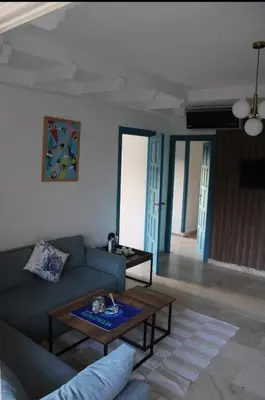 a living room with a couch and a table at K Playa Vibe Darbouazza in Dar Bouazza