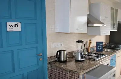 a blue door in a kitchen with a counter top at K Playa Vibe Darbouazza in Dar Bouazza