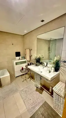 a bathroom with a sink and a large mirror at 2 Bedroom Apartment in Casablanca