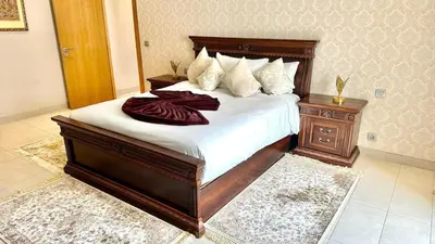 a bedroom with a large bed with white sheets at 2 Bedroom Apartment in Casablanca