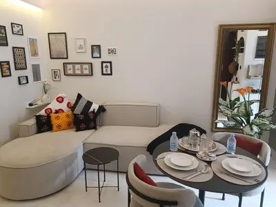 a living room with a bed and a table and chairs at Sunny Studio Apartment with Courtyard in Casablanca