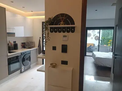 a kitchen and a living room with a bed at Sunny Studio Apartment with Courtyard in Casablanca