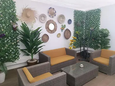 a living room with couches and plants on a wall at Sunny Studio Apartment with Courtyard in Casablanca