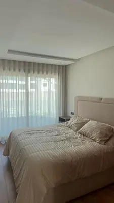 a bedroom with a large bed and a window at Oasis view in Casablanca