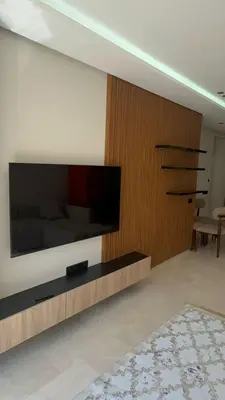 a living room with a large television on a wall at Oasis view in Casablanca