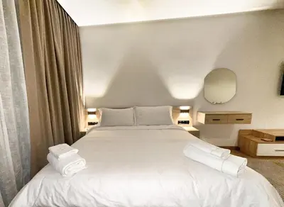 a bedroom with a large white bed with towels on it at 4-Marina Calma ocean-studio coconing vue mer in Casablanca
