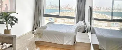 a bedroom with a bed and a large window at 4-Marina Calma ocean-studio coconing vue mer in Casablanca