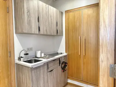 a kitchen with wooden cabinets and a sink at 4-Marina Calma ocean-studio coconing vue mer in Casablanca