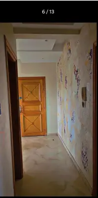 an empty room with a wooden door and a wall at Cozy Room with Private Bathroom and Balcony in Casablanca
