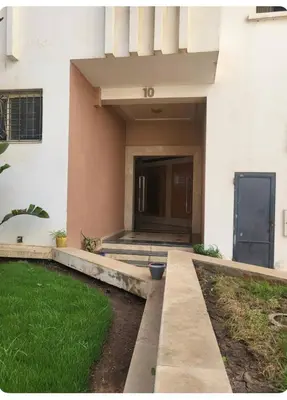 a front door of a house with a grass yard at Cozy Room with Private Bathroom and Balcony in Casablanca