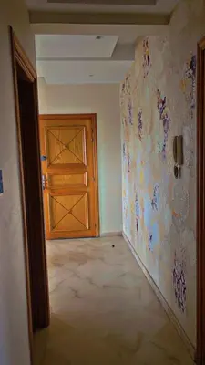 an empty room with a wooden door and a wall at Cozy Room with Private Bathroom and Balcony in Casablanca