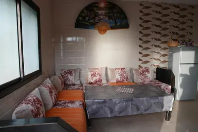 a living room with a couch and a table at Farm Fields and Forests 20 min from carrefour berchid in Berrechid