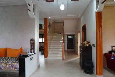 a living room with a staircase leading up to a house at Farm Fields and Forests 20 min from carrefour berchid in Berrechid