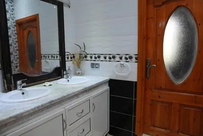 a bathroom with two sinks and a mirror at Farm Fields and Forests 20 min from carrefour berchid in Berrechid