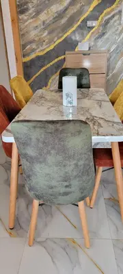 a table with a green chair and a table with a laptop on it at Perle Bouznika in Bouznika