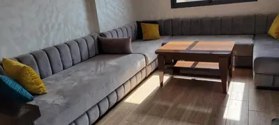 a living room with a couch and a wooden table at Perle Bouznika in Bouznika