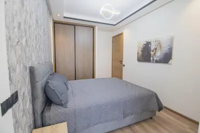 a bedroom with a bed and a painting on the wall at Appartement cosy et moderne au cœur de Casablanca in Casablanca