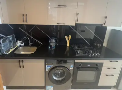 a kitchen with a stove top oven next to a sink at Appartement cosy et moderne au cœur de Casablanca in Casablanca
