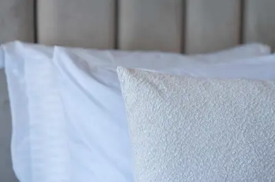 a white bed with white sheets and a pillow at Elegant Comfort Pool Gym & Kids Club in Mohammedia