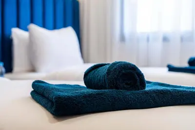 a blue towel sitting on top of a bed at Elegant Comfort Pool Gym & Kids Club in Mohammedia