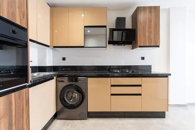 a kitchen with a washer and a washing machine at Elegant Comfort Pool Gym & Kids Club in Mohammedia