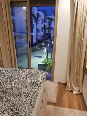 a bedroom with a bed and a window with a view at Luxury apartment in Oulad Mbark