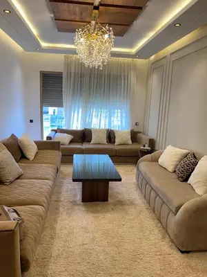 a living room with couches and a chandelier at Luxury apartment in Oulad Mbark