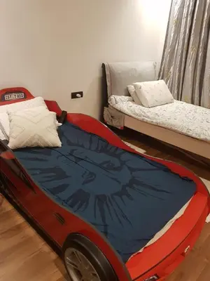 a bedroom with a bed with a car on it at Luxury apartment in Oulad Mbark