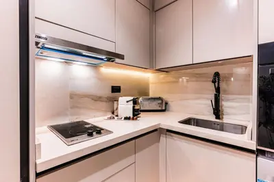 a kitchen with white cabinets and a sink at La Corniche - Seaside - Hassan II in Casablanca