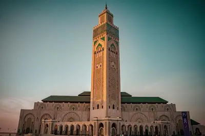 a large clock tower in front of a building at La Corniche - Seaside - Hassan II in Casablanca
