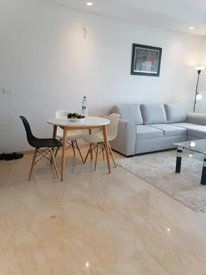 a living room with a couch and a table at plénitude in Mohammedia