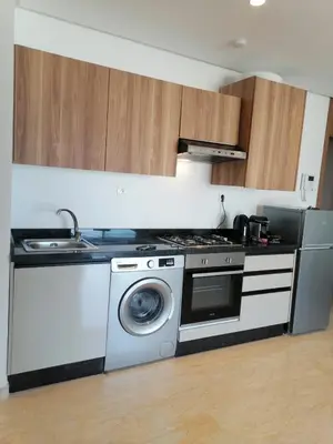 a kitchen with a stove and a washing machine at plénitude in Mohammedia