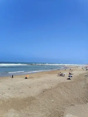 a group of people on a beach near the ocean at plénitude in Mohammedia