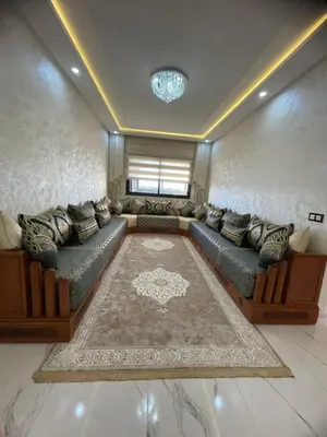 a large living room with couches and a rug at Apparemment propre pour les familles in Casablanca